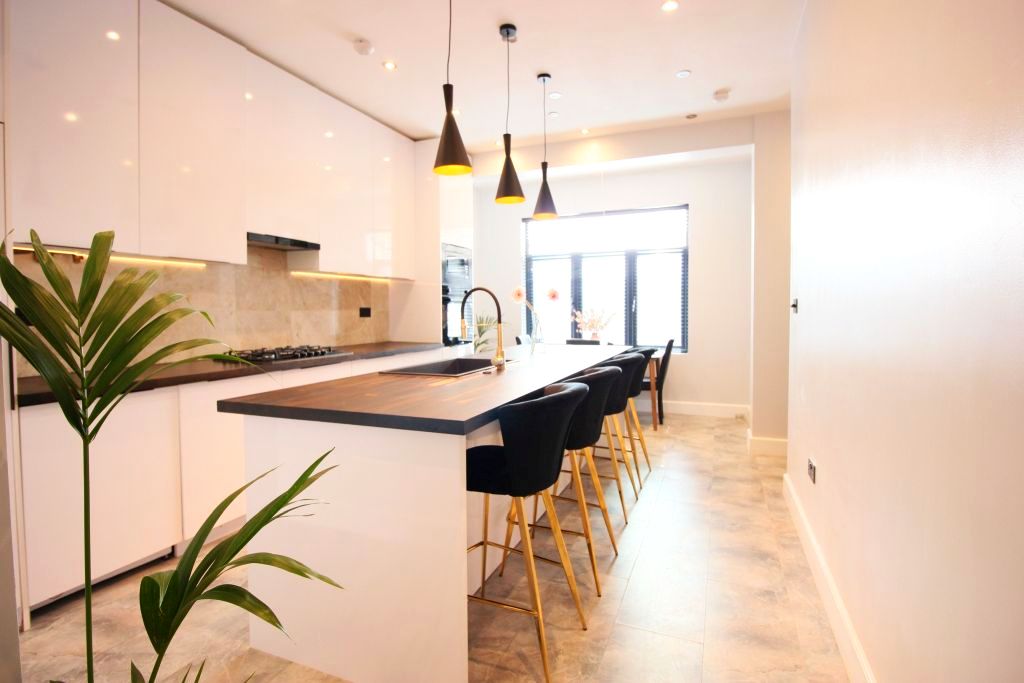 A large, high-spec kitchen with a marble island
